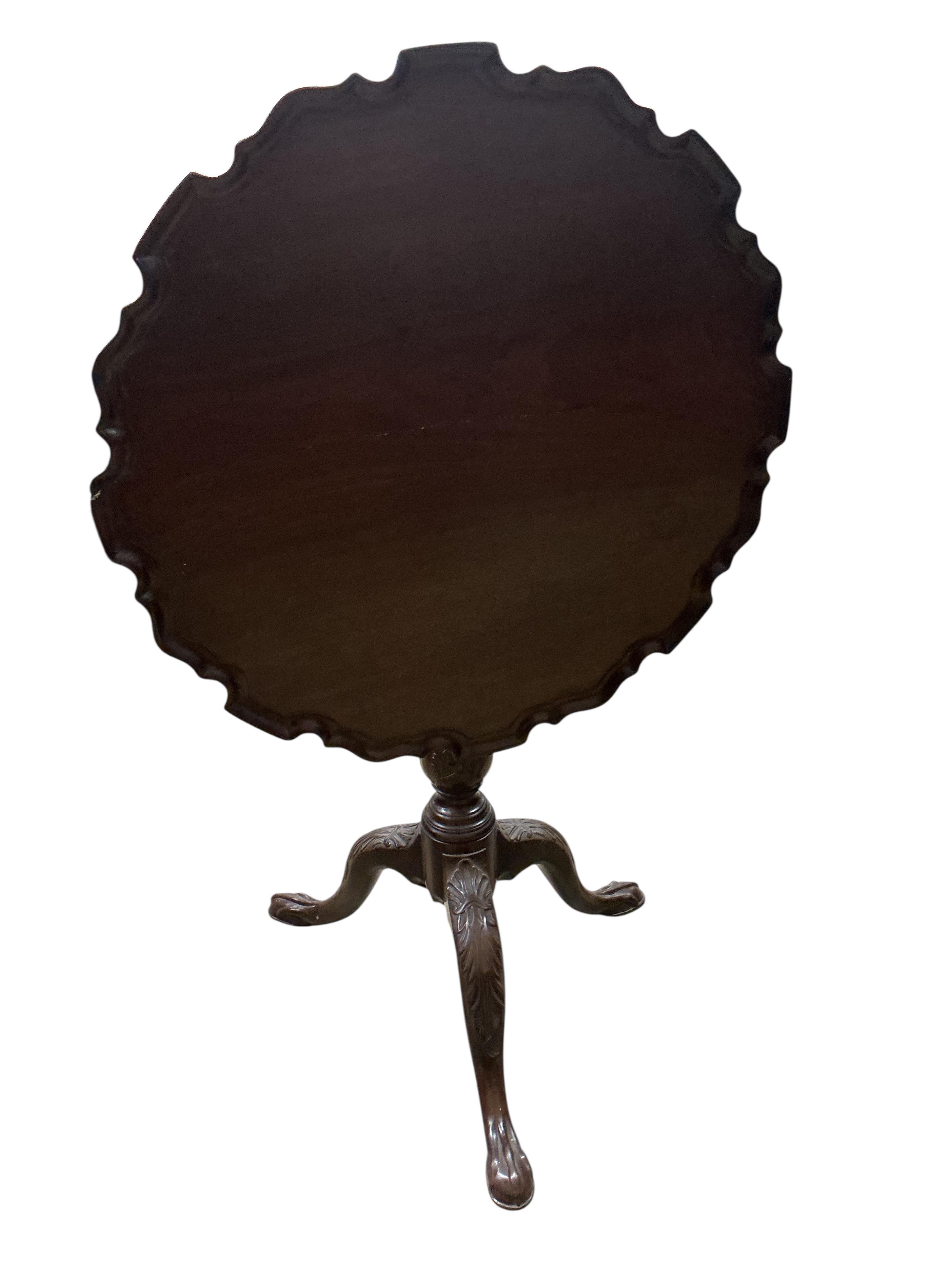 A George III circular mahogany piecrust tilt top bird cage tripod tea table, diameter 64cm, height 71cm (repair to top)